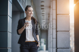 Fototapety Successful businesswoman talking on cellphone.
