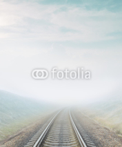 railroad goes to horizon in fog