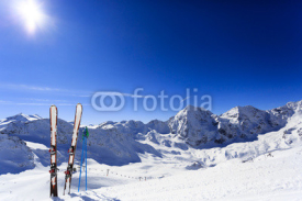 Fototapety Skiing, mountains and ski equipments on ski run