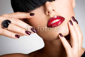 Fototapety Closeup face of a woman with beautiful sexy red lips and dark na