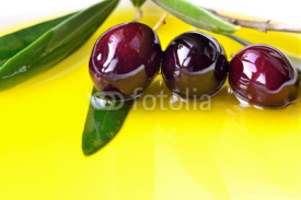 Obrazy i plakaty Olive oil  background with black olives closeup