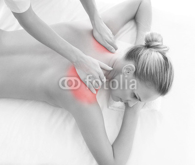 A woman getting massaging treatment over white background