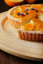 Homemade orange tart with coffee grains on wooden background