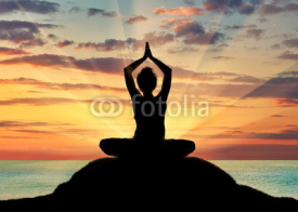 Fototapety Silhouette of a girl practicing yoga