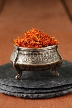 Fototapety Saffron spice in metal bowl macro shot soft focus