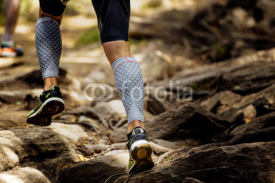 Naklejki marathon runner running rocks in mountain. closeup of legs compression socks and shoes