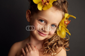 Beauty portrait of a little girl with flowers in her hair