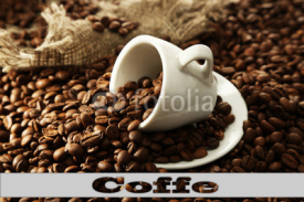 Cup of coffee on coffee beans close-up background