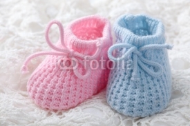 Fototapety Blue and pink baby booties on white background